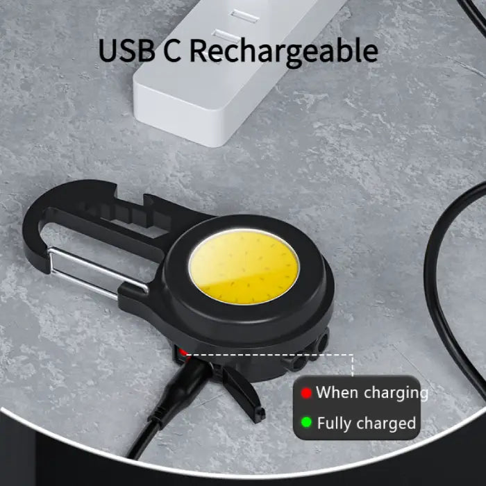 LED carabiner light with charging indicator showing red and green status lights for battery level