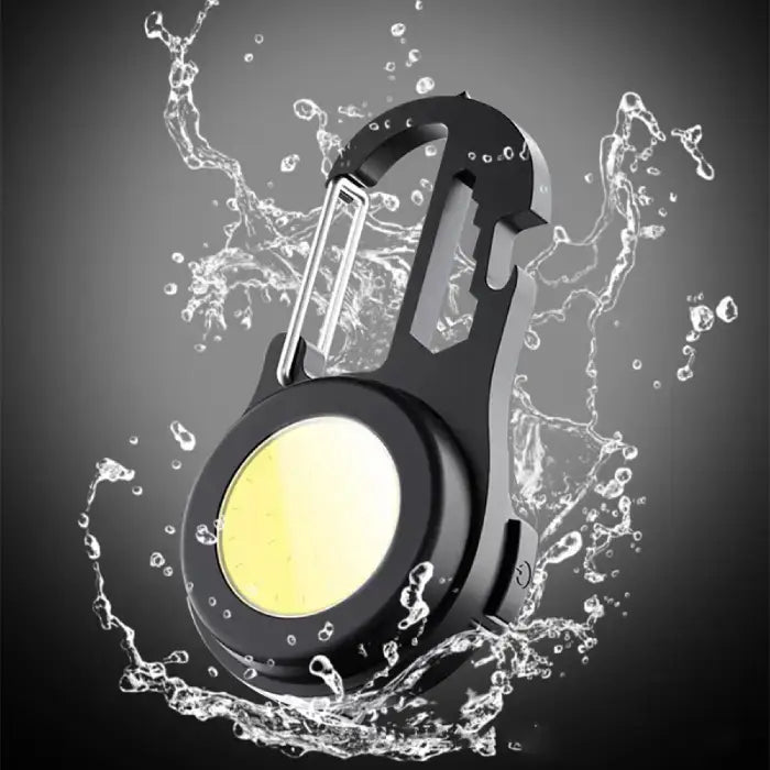 Water splash demonstration showing waterproof capability of black LED carabiner light