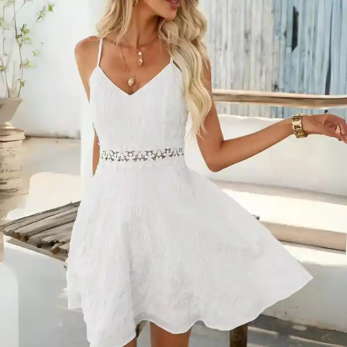 White crochet spaghetti strap dress swinging mid twirl with airy skirt and floral waist.