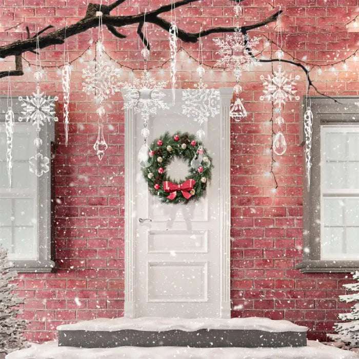 Snow-covered doorway with hanging crystal snowflakes and Christmas wreath against red brick wall