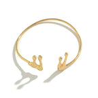 Gold bracelet with snail designs on a white background
