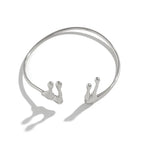 Silver choker necklace with three pendant hooks on a white background