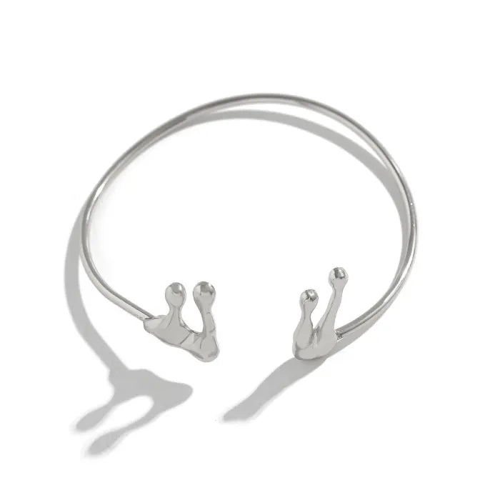 Silver choker necklace with three pendant hooks on a white background