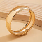 Gold ring on a beige background