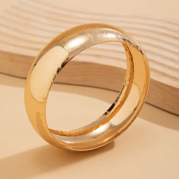 Gold ring on a beige background