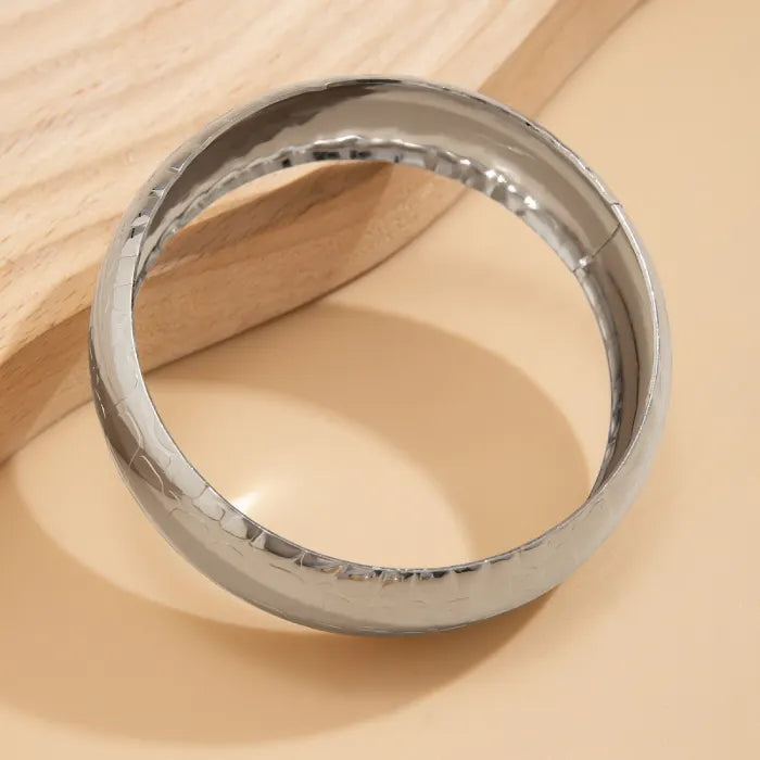 Silver ring on a wooden surface