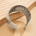 Gray headband with striped pattern on a wooden surface