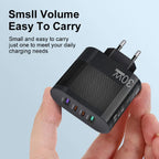 30W 4 port fast USB charger shown in hand highlighting small and easy-to-carry size.