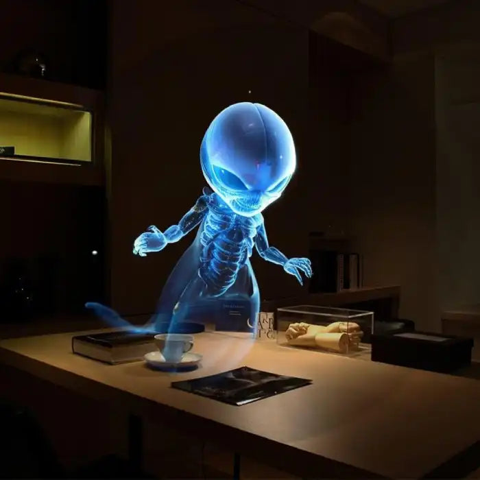 3D Hologram maker projecting a blue alien figure with x-ray style visual above desk