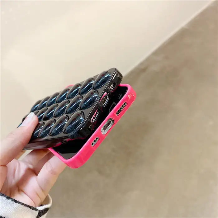 3d iphone protective case with 3d heart shapes, showing charging port and speaker