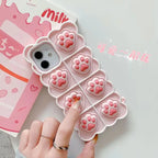 3D silicone phone case with pink cat paw design showing textured toe beans and scalloped border for iPhone protection