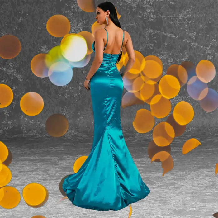 Rear view showcasing the low backless design and slight train of the teal satin evening gown. Order this stunning backless formal dress now.
