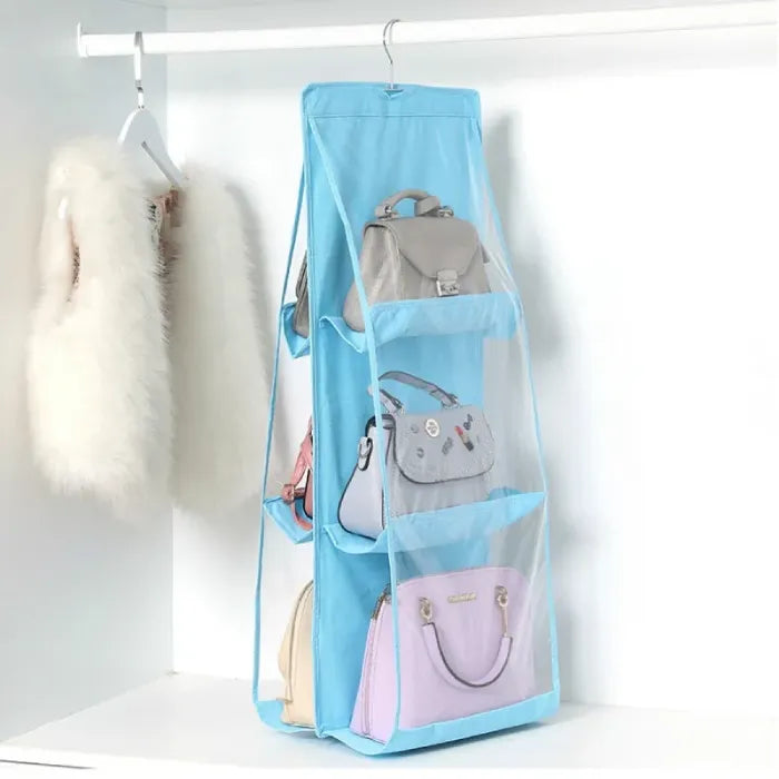 Blue organizer with handbags in a closet