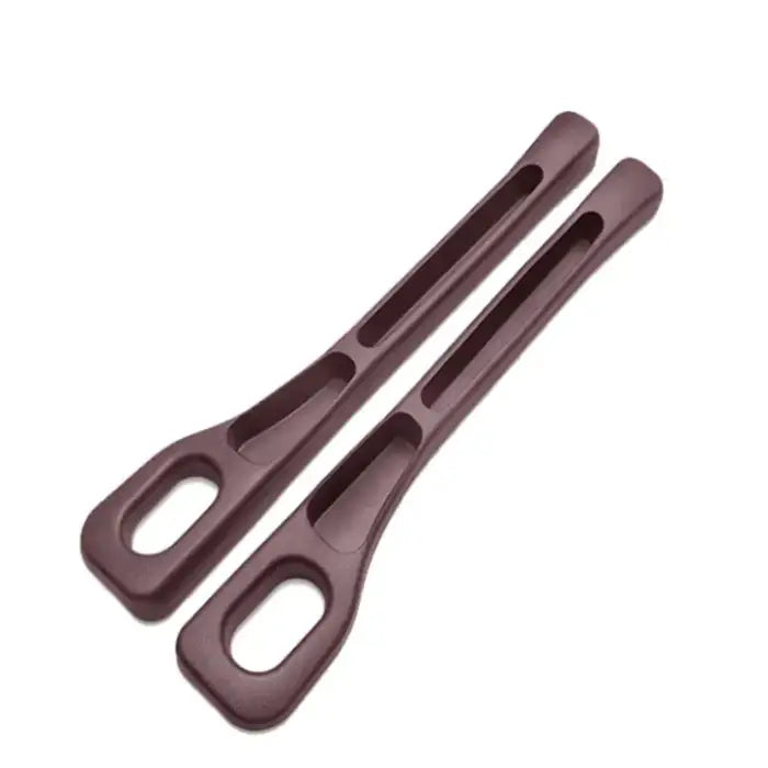 Pair of brown plastic car seat gap fillers featuring ergonomic design with storage slots