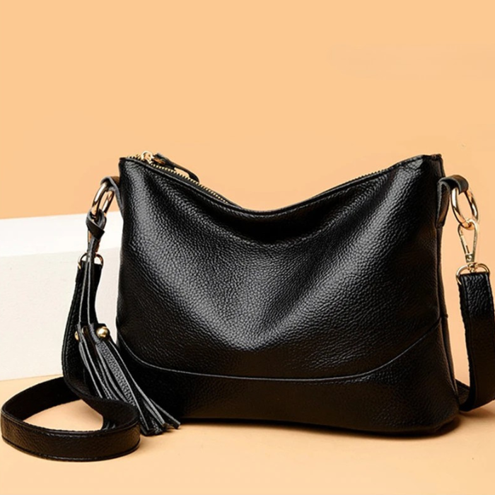 Chic black leather crossbody bag with tassel, a must-have accessory for stylish outfits.