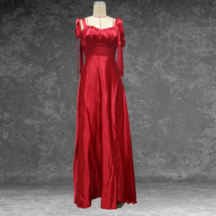 Mannequin displaying an elegant red satin prom dress. Perfect formal wear featuring prominent shoulder bows and a long skirt.