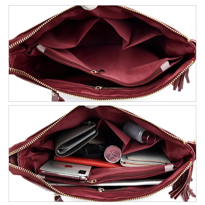 Inside view of a red leather handbag revealing spacious compartments and zippers.