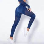 Mesh panel high-waist legging in navy blue with sheer stripe accents and athletic fit.