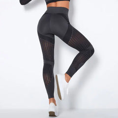 Mesh panel high-waist legging in charcoal black with stretch fit and vertical mesh details.