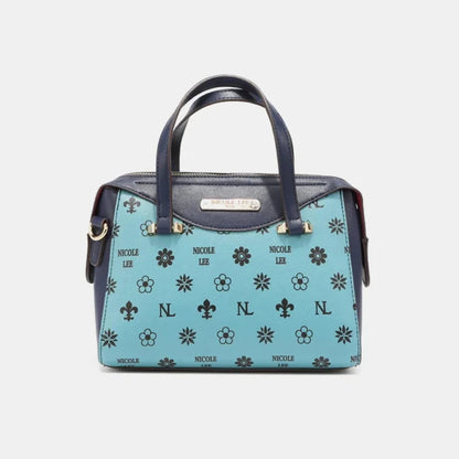 Light blue satchel handbag with floral and monogram pattern, navy trim, and gold hardware