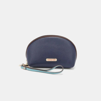 Navy blue cosmetic bag with gold logo plate and light blue patterned wristlet strap