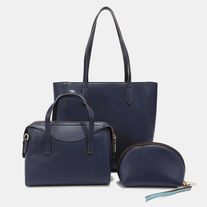 Nicole Lee Solid navy blue handbag set featuring tote, satchel, and cosmetic bag with leather handles and gold hardware