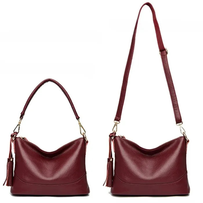 Red leather handbag featuring short and long strap options for different styles.