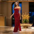 Radiant red sequin prom dress with thin straps, high side slit and body-contouring fit, photographed in classical setting with stone balustrade