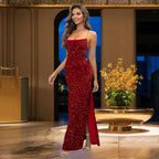 Radiant red sequin prom dress with thin straps, high side slit and body-contouring fit, photographed in classical setting with stone balustrade