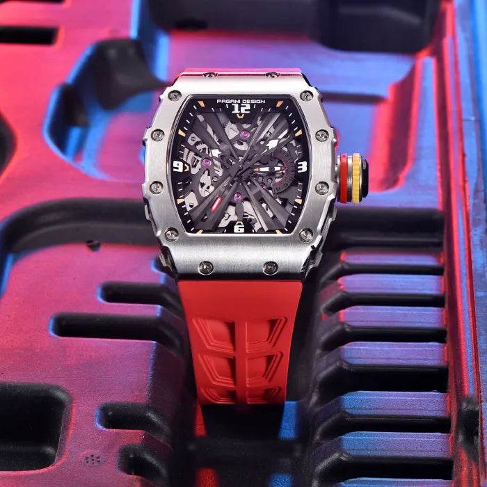 Industrial style Pagani watch with orange strap against a vibrant mechanical setting.