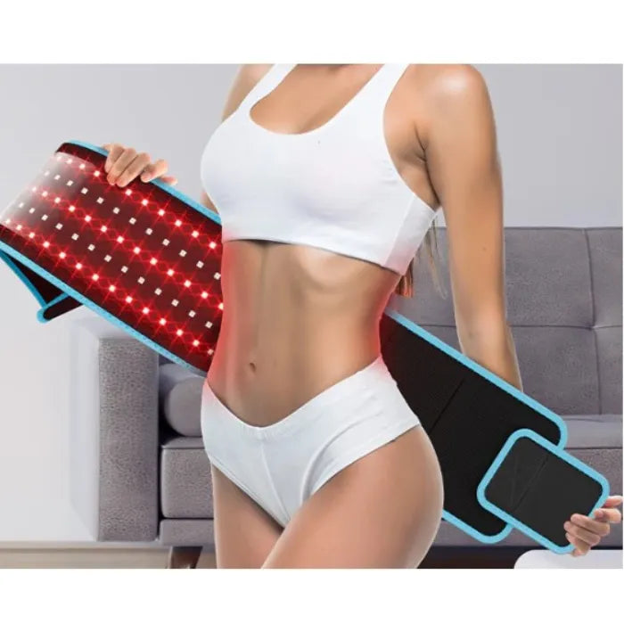 Athletic woman holding red light therapy belt, demonstrating its use for waist and abdominal area