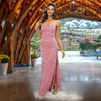 Glamorous pink sequin prom dress with form-fitting silhouette, thin spaghetti straps and side slit detail, styled with silver accessories