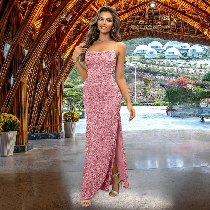 Glamorous pink sequin prom dress with form-fitting silhouette, thin spaghetti straps and side slit detail, styled with silver accessories