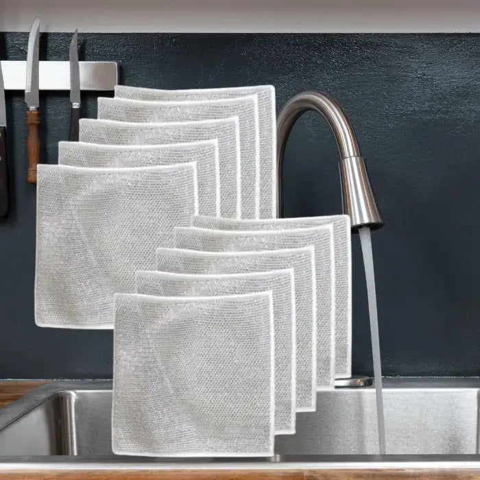 set of 10 silver mesh dish cloths neatly arranged on a kitchen sink, showcasing their durable and reusable design for effective cleaning.