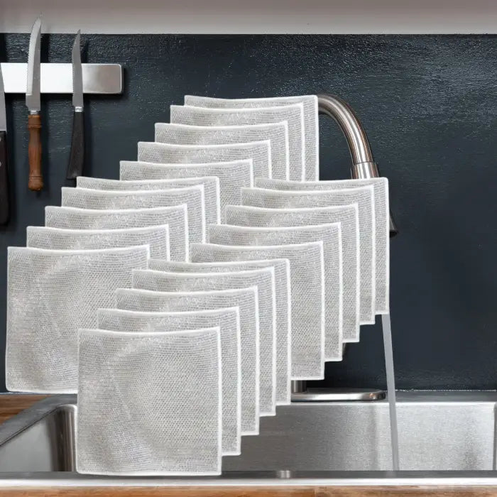 set of silver 20 mesh dish cloths neatly arranged on a kitchen sink, showcasing their durable and reusable design for effective cleaning.