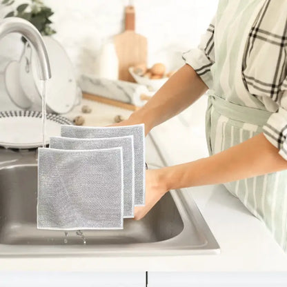 set of 3 silver mesh dish cloths neatly arranged on a kitchen sink, showcasing their durable and reusable design for effective cleaning.