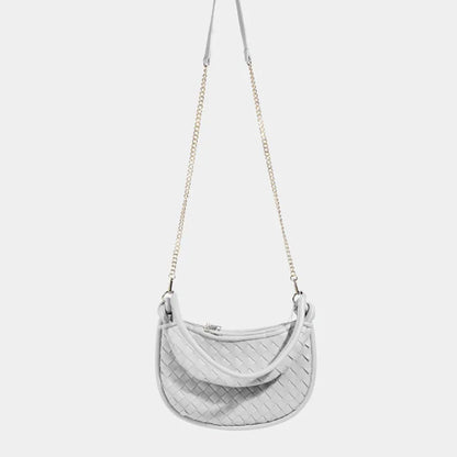 Silver white woven leather crossbody bag with gold chain strap and curved shape