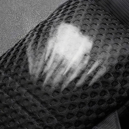 Black and white close-up of textured surface on sling bag, showing intricate pattern and breathable quality material