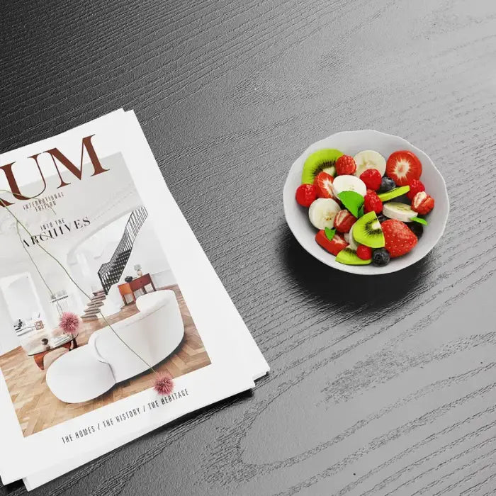 Magazine and colorful fruit bowl on textured wooden surface, highlighting high-quality, waterproof, and scratch-resistant features