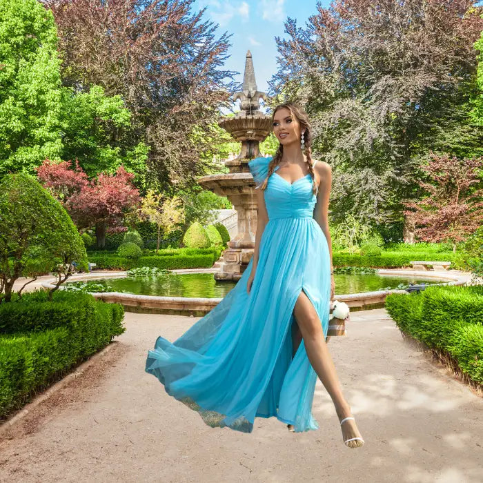Woman walks in a garden wearing a beautiful flowy light blue prom dress, highlighting the high leg slit and movement.