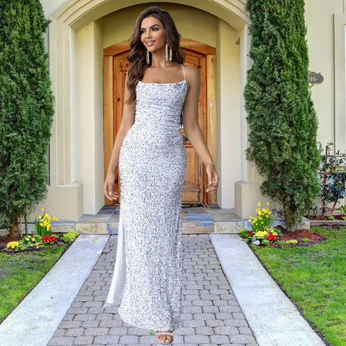  Elegant white sequin prom dress with fitted silhouette, spaghetti straps and refined side slit, styled with silver accessories for formal events