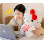 Woman at laptop with Hello Kitty plush