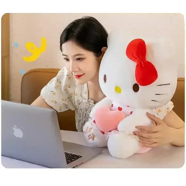 Woman at laptop with Hello Kitty plush