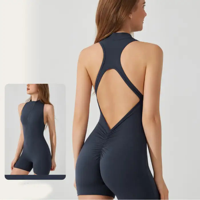 activewear jumpsuit in navy blue featuring zip front design with diamond-shaped open back and stylish ruched detailing for movement