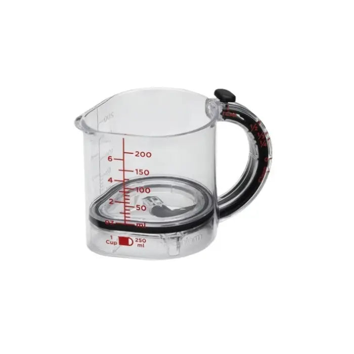 Adjustable measuring cup empty, showing clear body with red measurement markings.