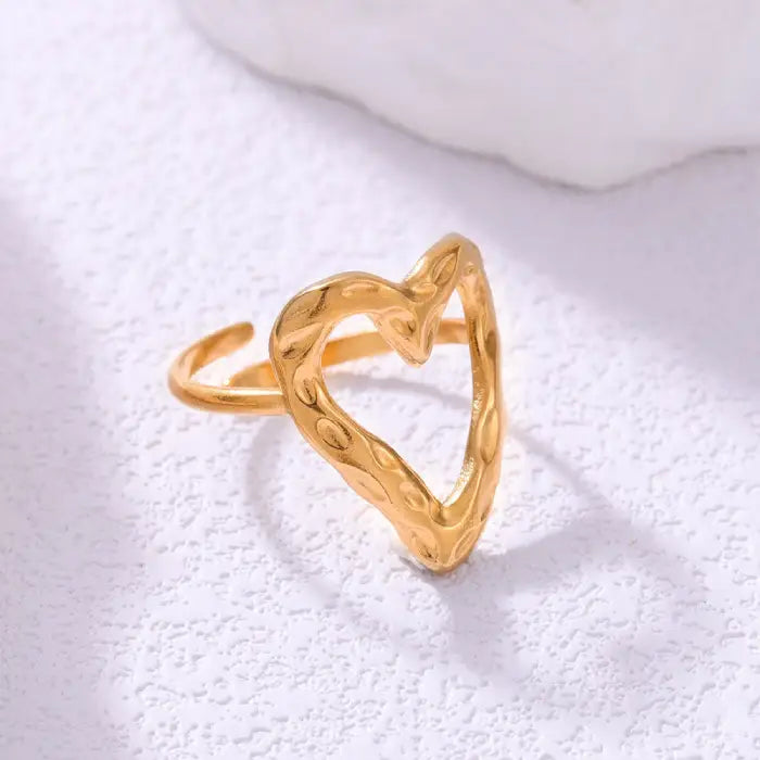 adjustable open heart ring in gold with hammered texture displayed on soft surface, creating a minimalist elegant look ideal for gifting