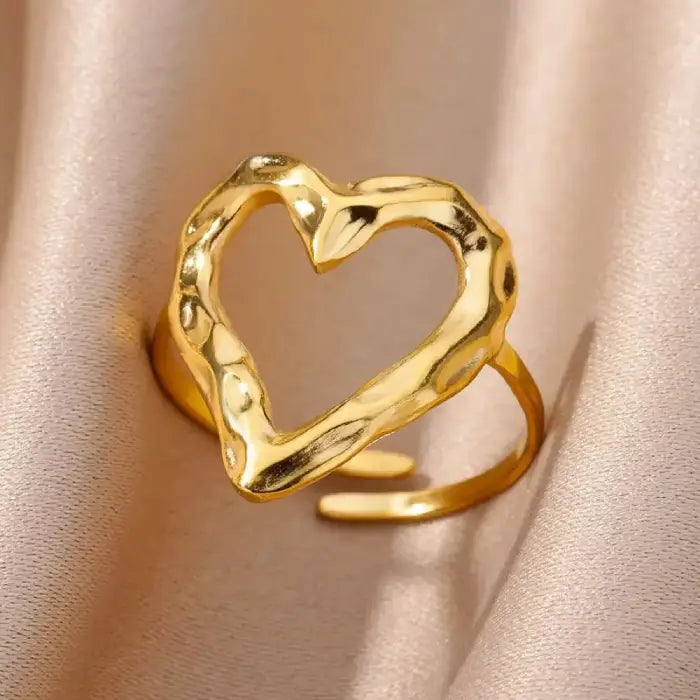 adjustable open heart ring in polished gold with textured design displayed on satin, creating an elegant premium minimalist jewelry look