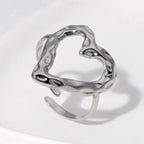 adjustable open heart ring in textured silver design shown on white surface, offering a modern minimalist sculpted style ideal for gifting