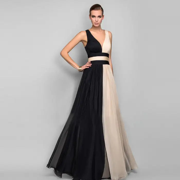 Front view pose in the affordable v neck backless evening dress, color-blocked black and cream. Shop our collection of elegant formal gowns with free delivery now.