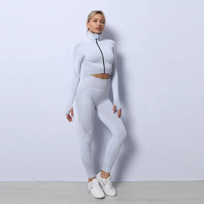 Three-piece seamless yoga set for women in all white, high neck zip jacket and tights.